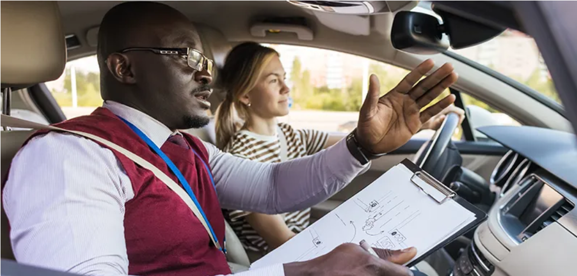 Professional driving instructor teaching a California student during behind-the-wheel lesson